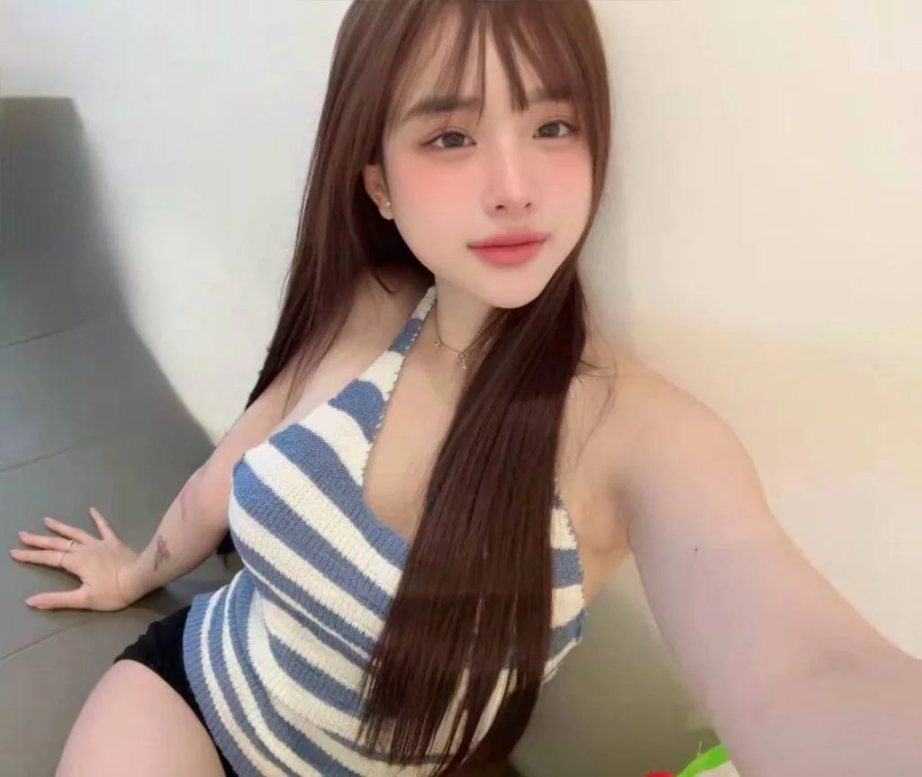 Ummi Singapore Escort standing in a private Bishan room setting
