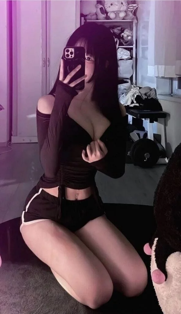 Relaxed indoor photo of Jiyoung Singapore Escort smiling gently in a private setting